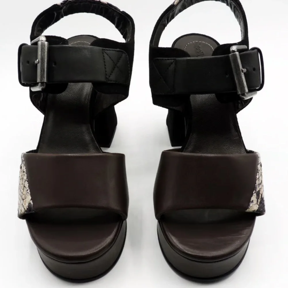 See by Chloe . Black , brown and python print platform heels.